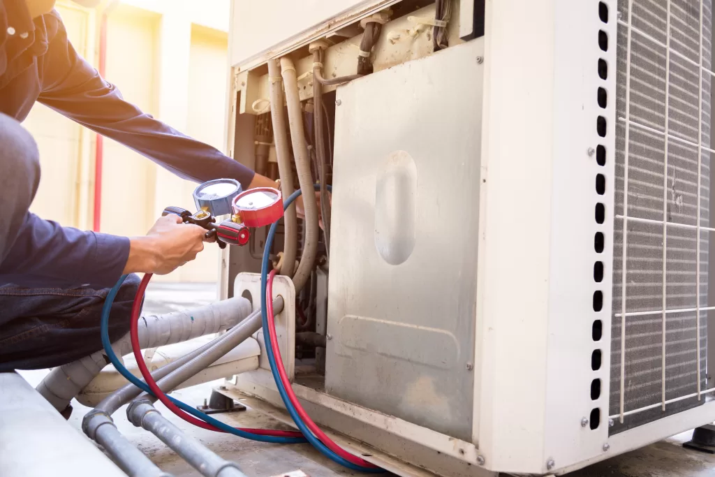 The HVAC expert performs a system pressure check to ensure optimal functioning