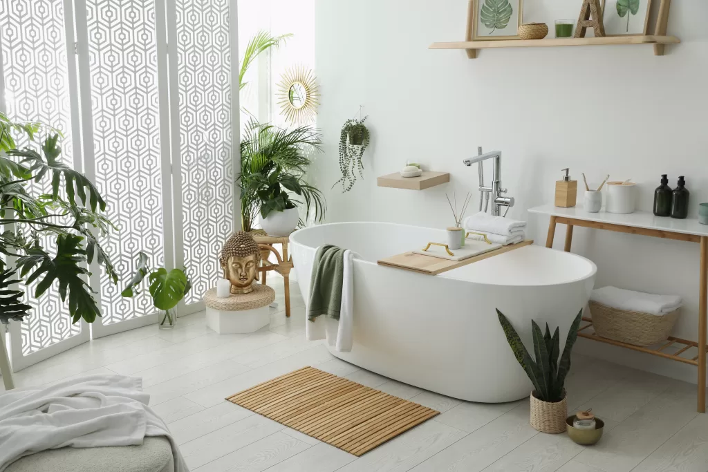 Stylish bathroom interior with modern tub, houseplants and beautiful decor