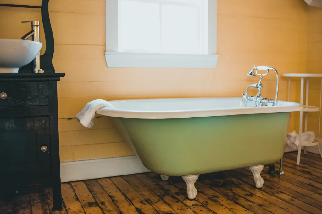 A bathtub in a vintage style with intriguing designer furnishings