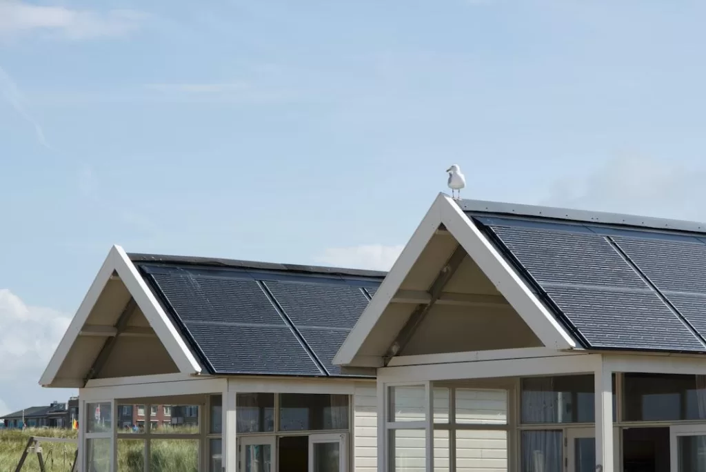 A cropped image of two homes fitted with solar panels side by side