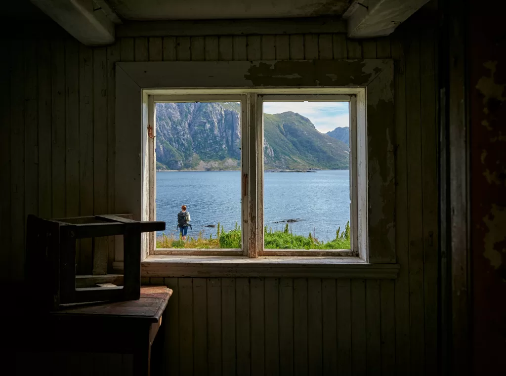 a wooden window with a view of the mountains